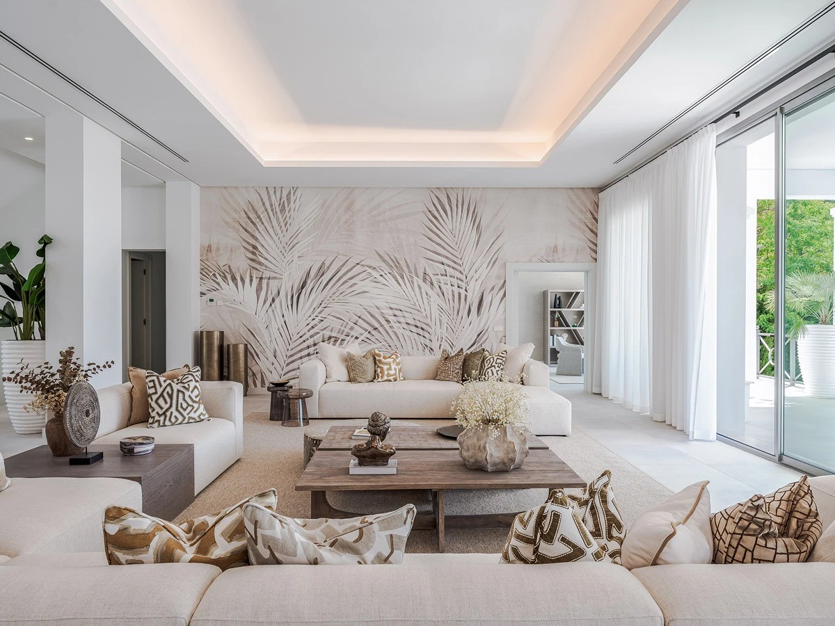 Finished living room with leaf-pattern wallcovering and tailored furnishings