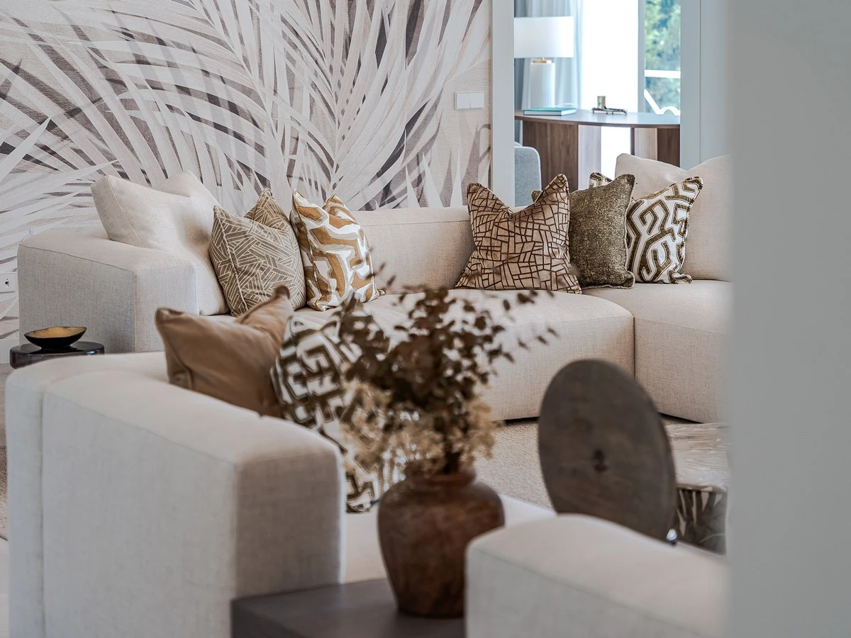 Layered cushions, upholstery and wallcovering in the El Madroñal living room