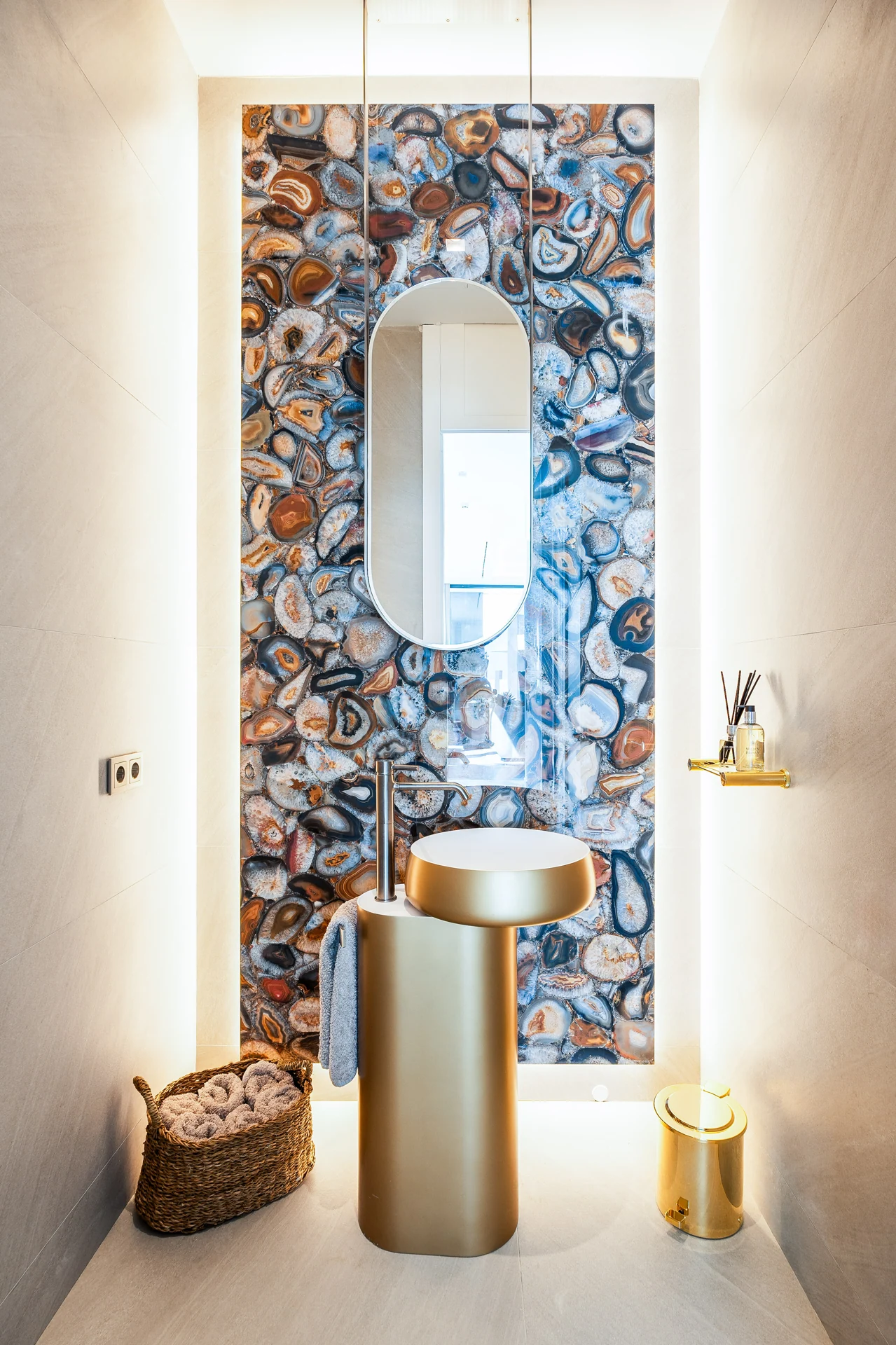 Decorative cloakroom with a patterned wall and illuminated mirror