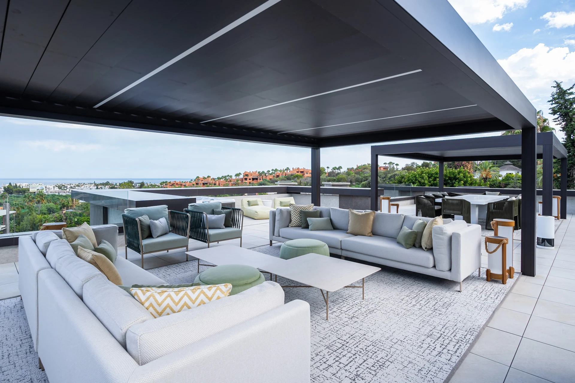 Covered roof terrace with outdoor sofas