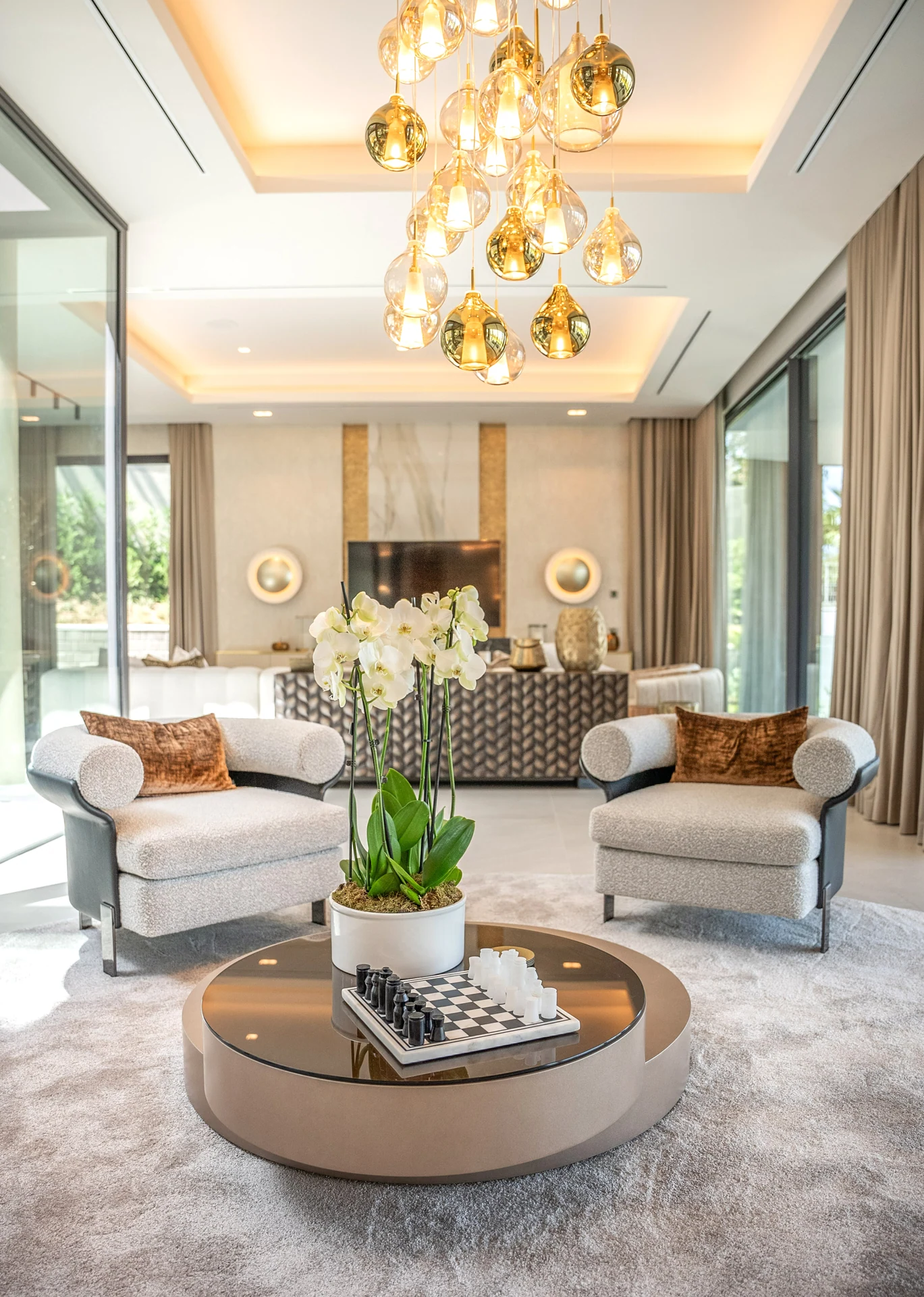 Double-height living room with decorative chandeliers