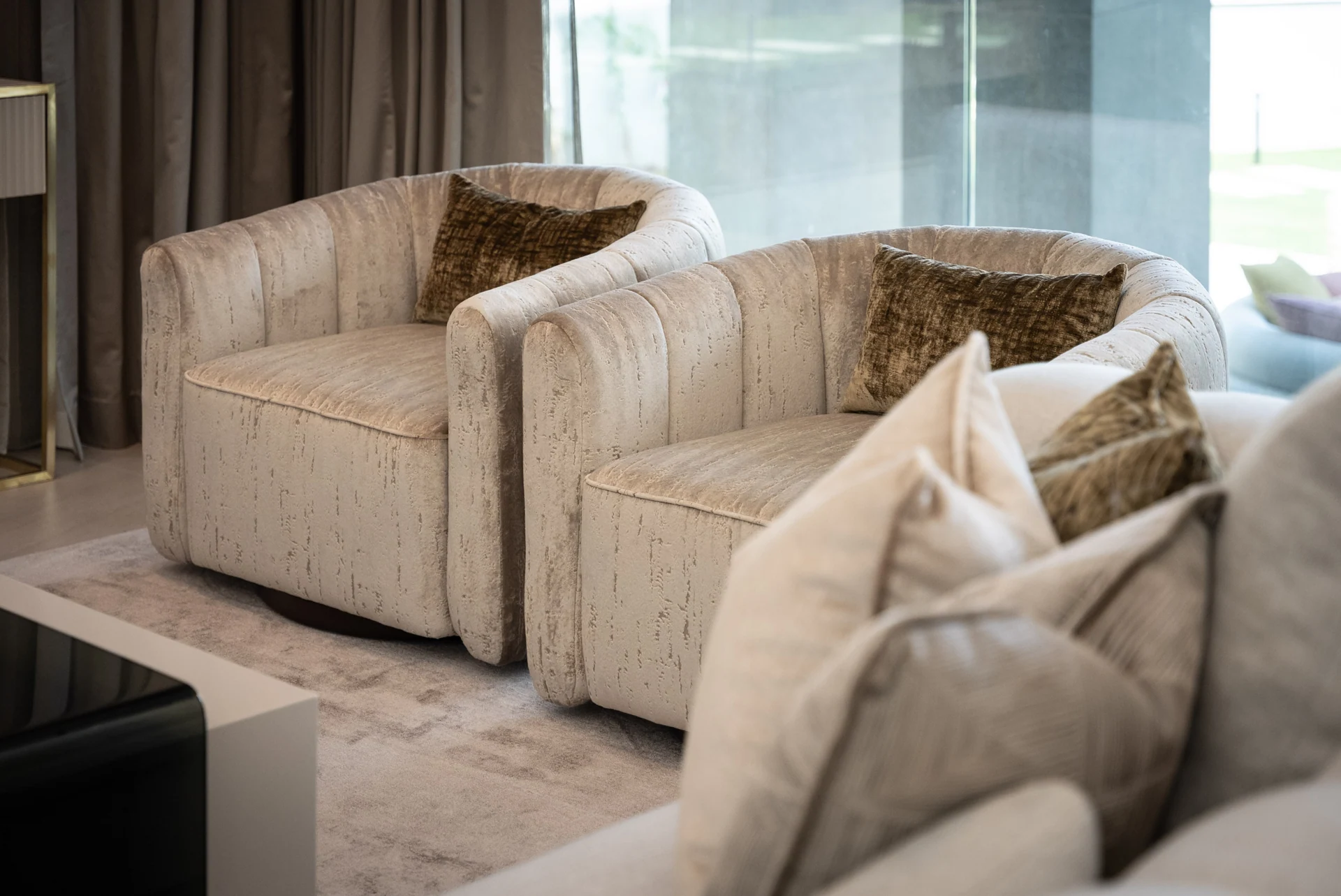 Layered cushions and textured armchairs
