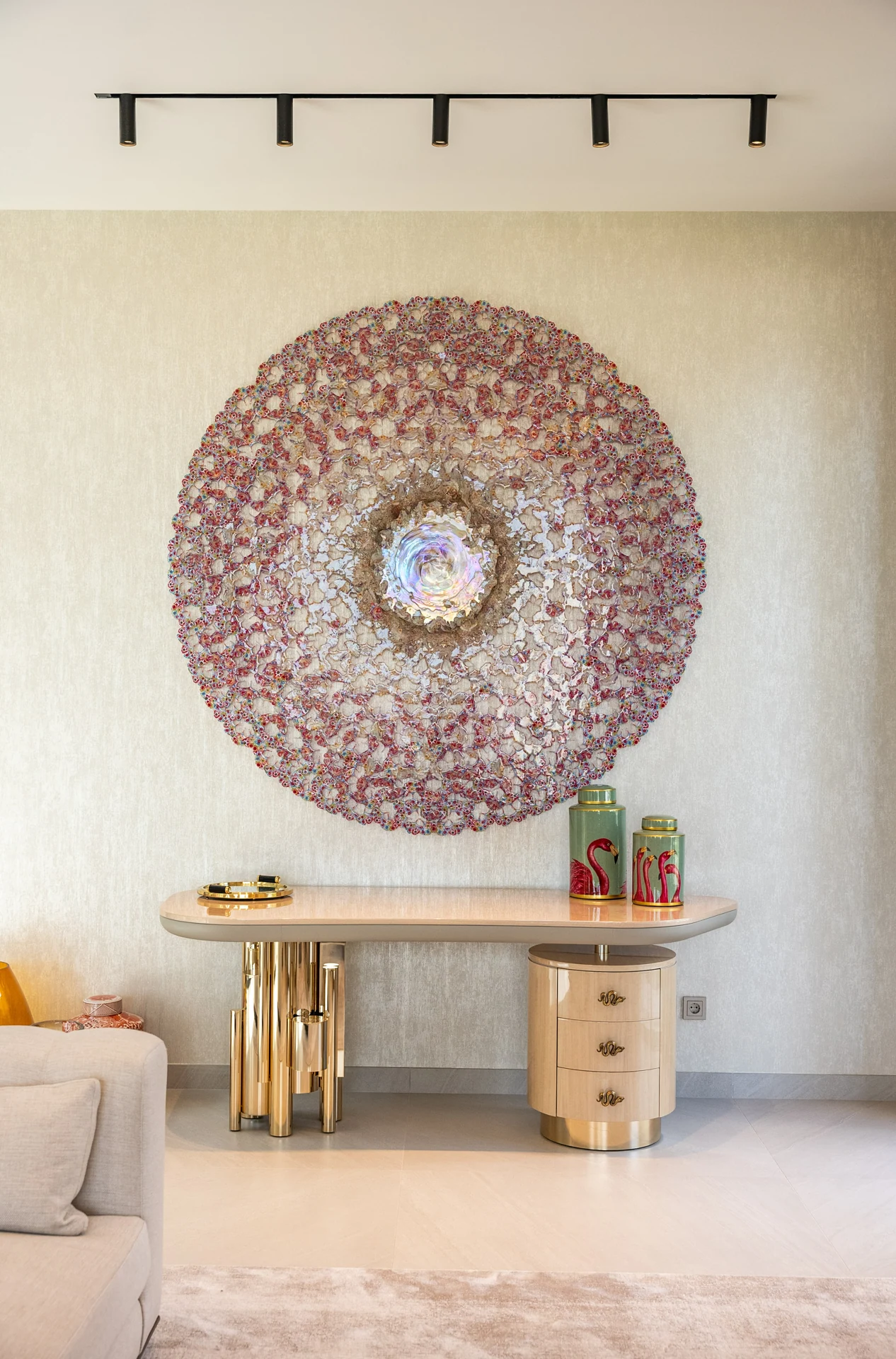Decorative console beneath a circular wall piece