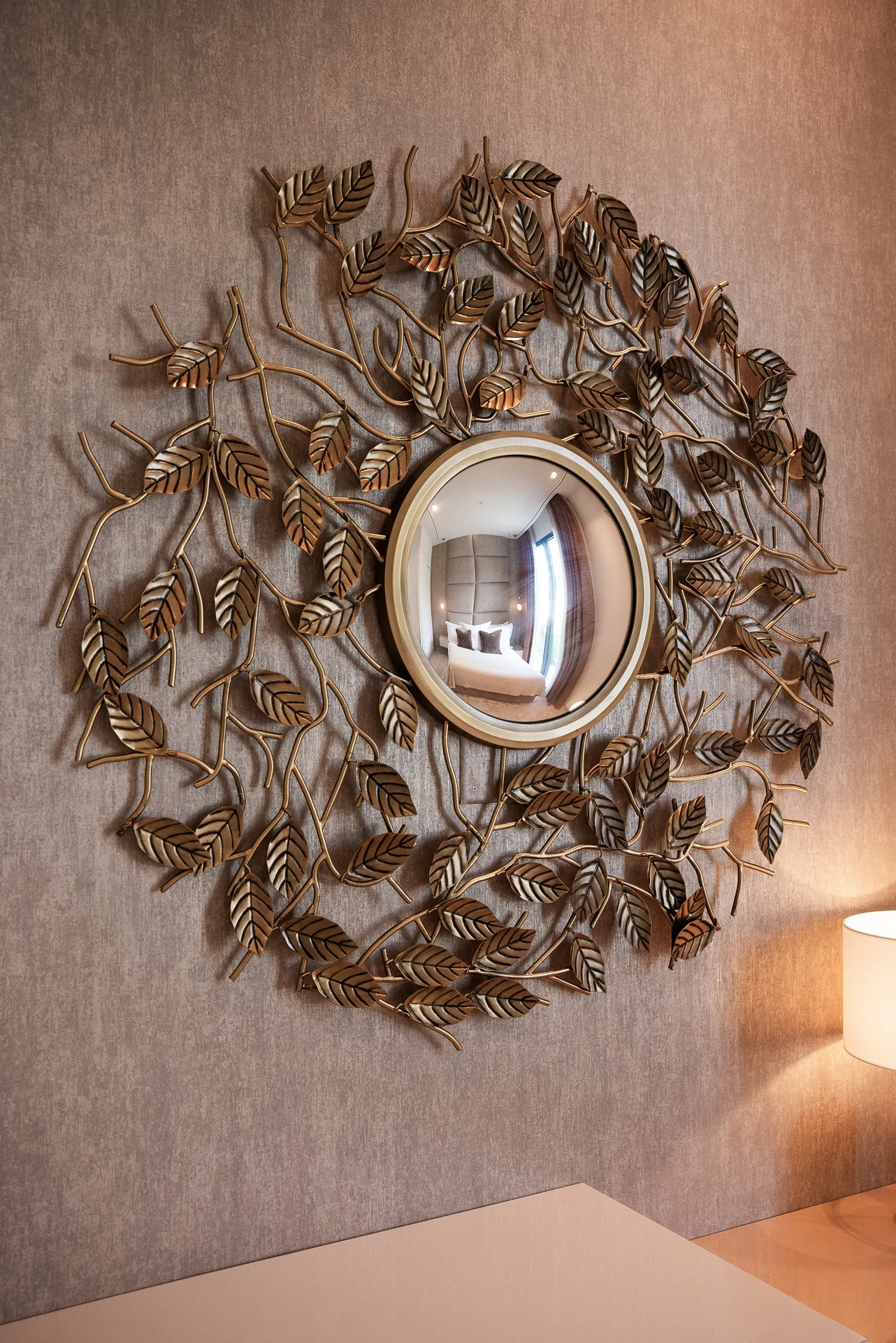 Ornamental mirror on a textured wall