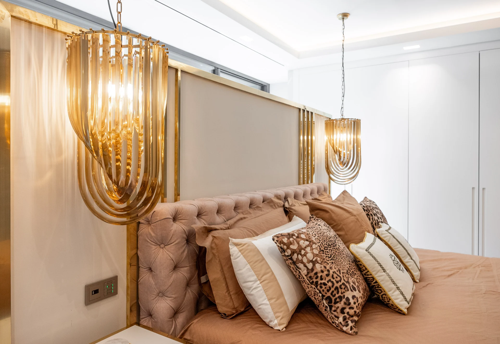 Tufted headboard and decorative bedside lighting