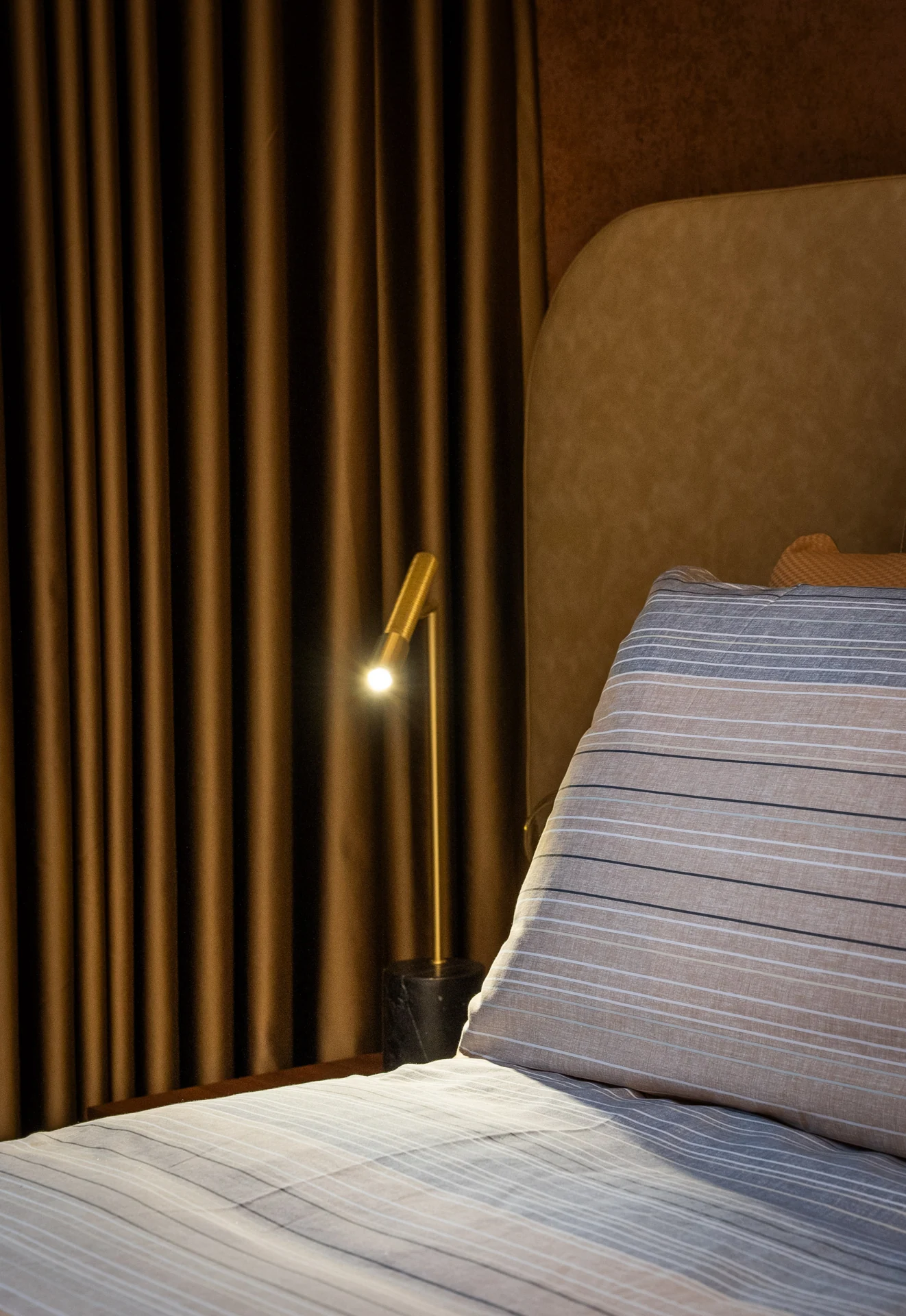 Vertical timber detailing beside an upholstered headboard