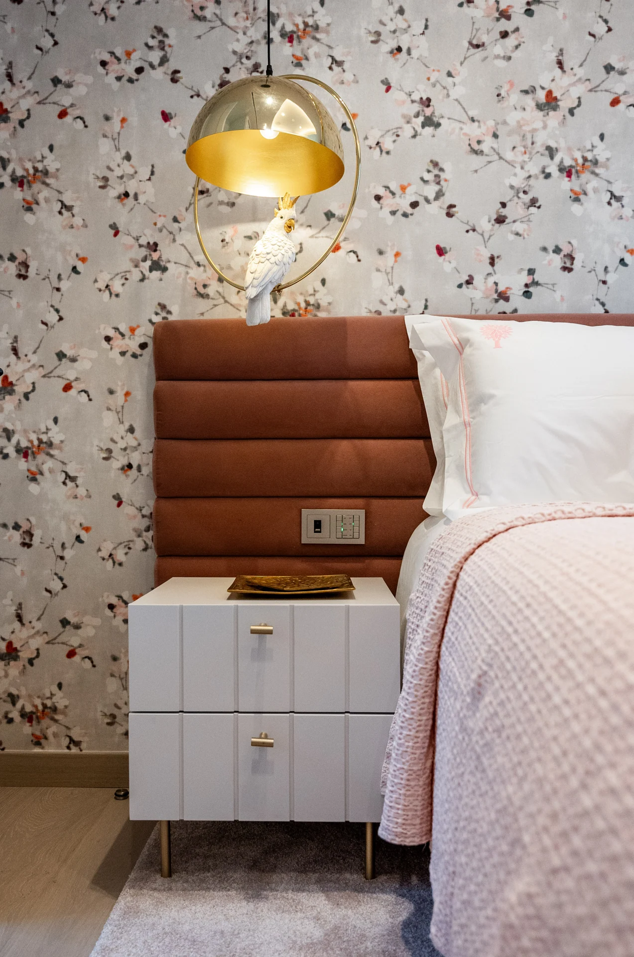Bedside furniture and patterned bedroom wallcovering