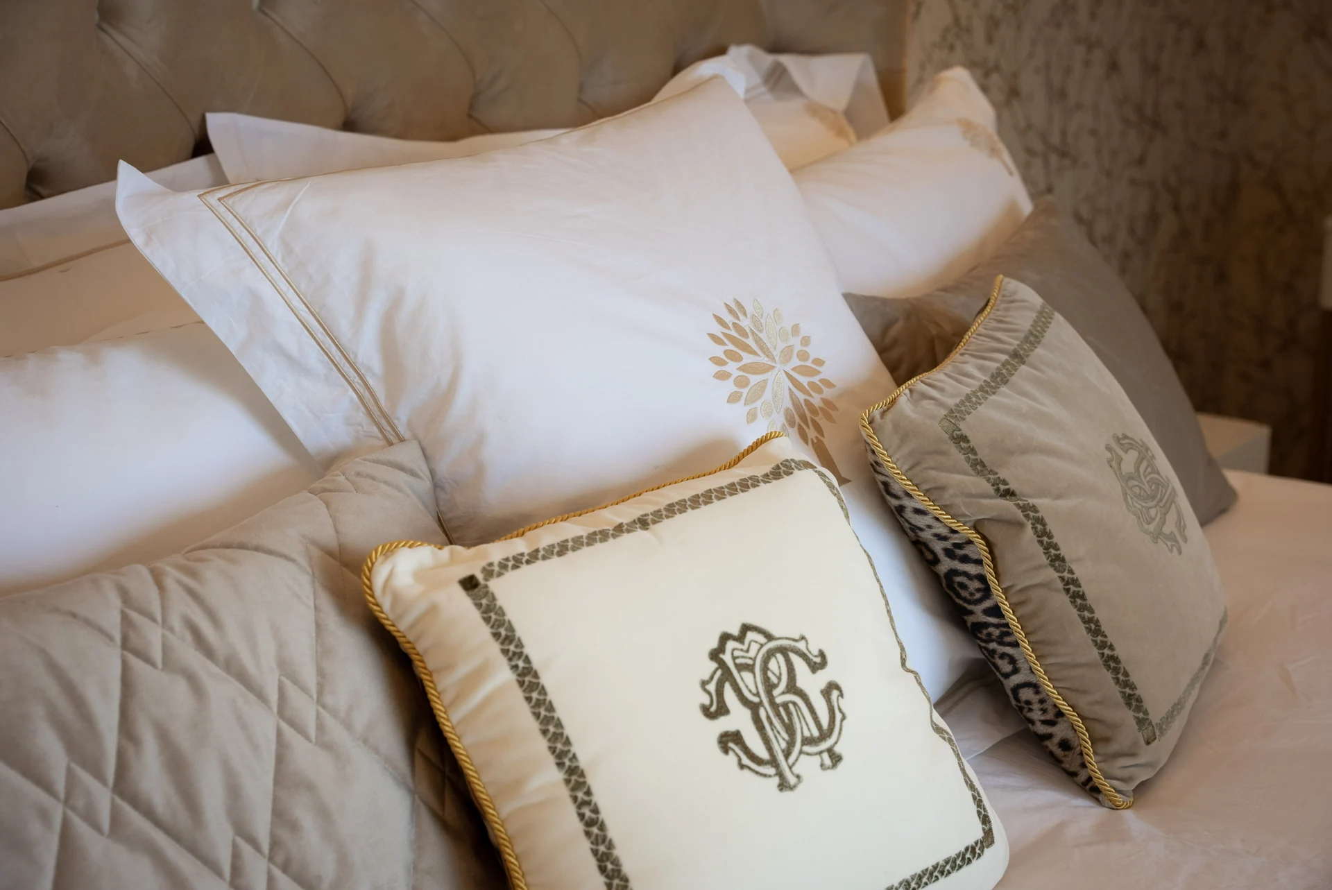 Embroidered cushions and layered bedding