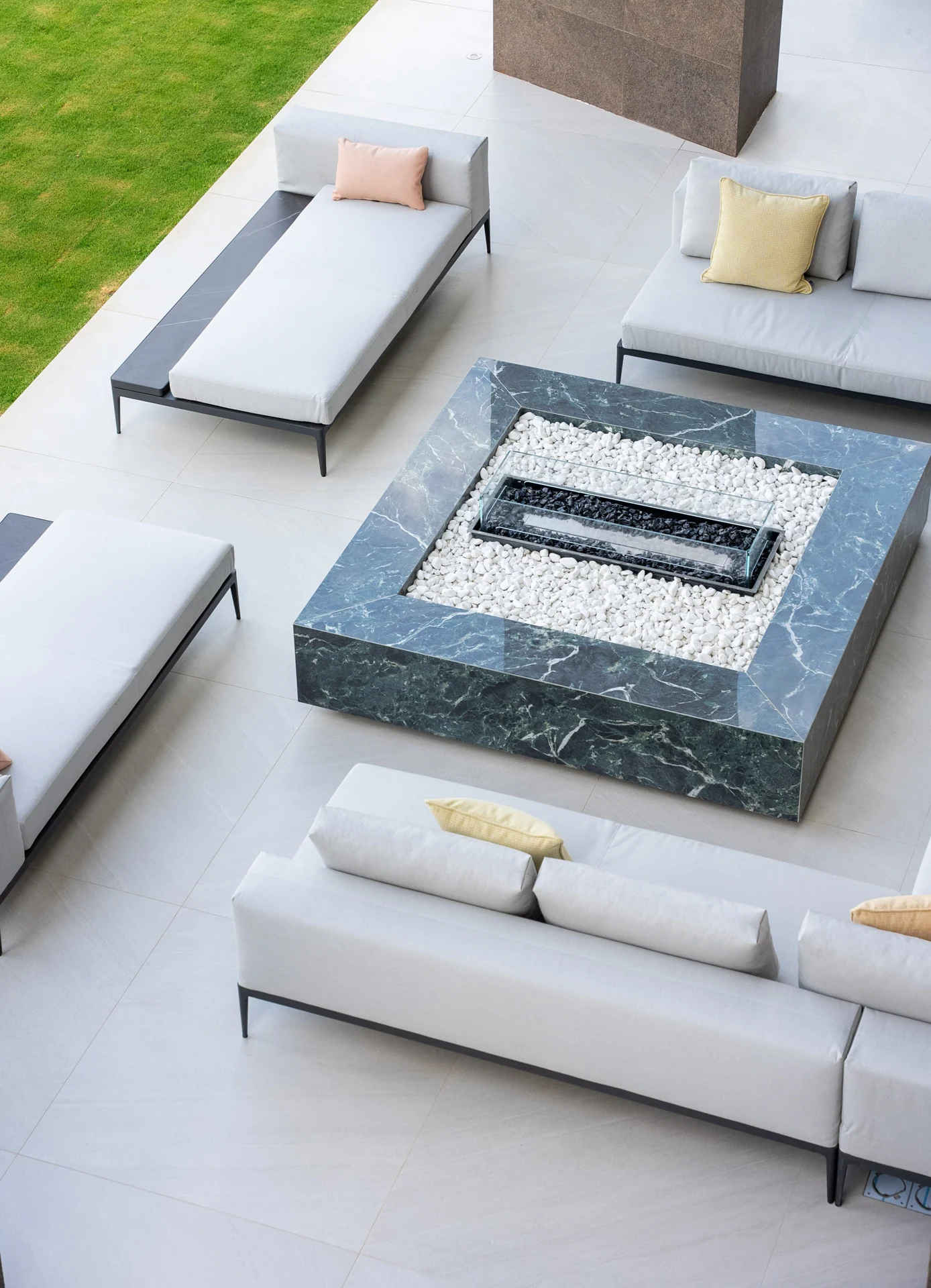 Sunken outdoor seating arranged around a fire feature