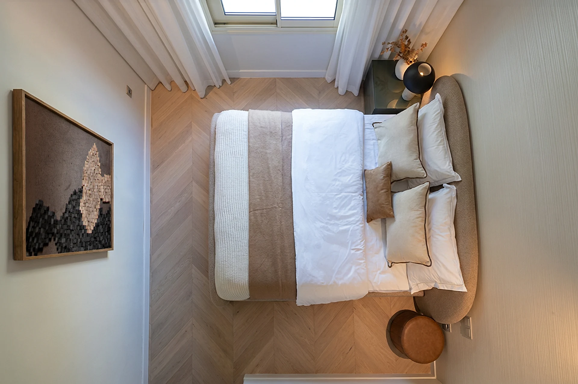 Overhead view of the upholstered bed and timber floor
