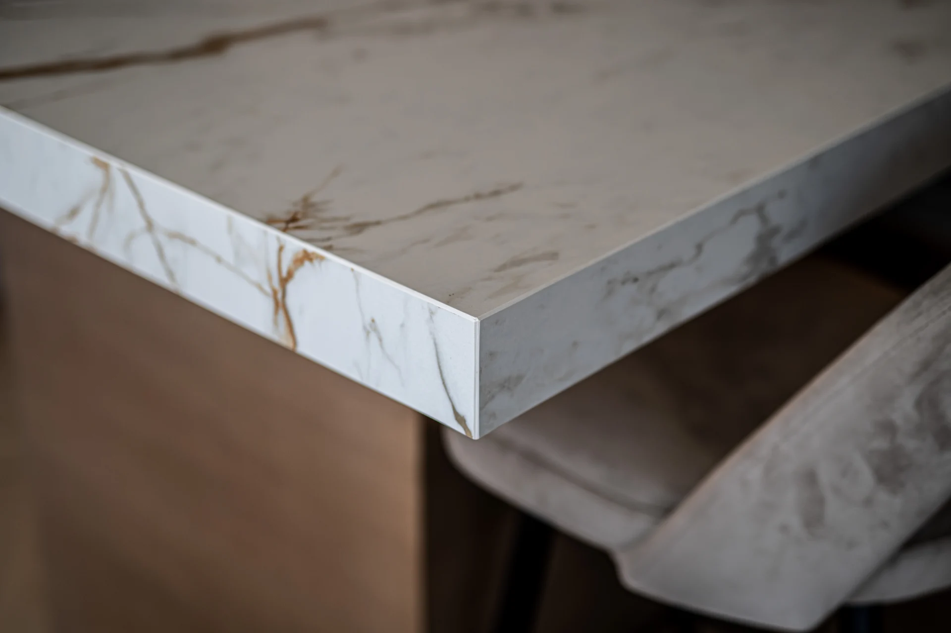 Veined kitchen worktop and timber island detail