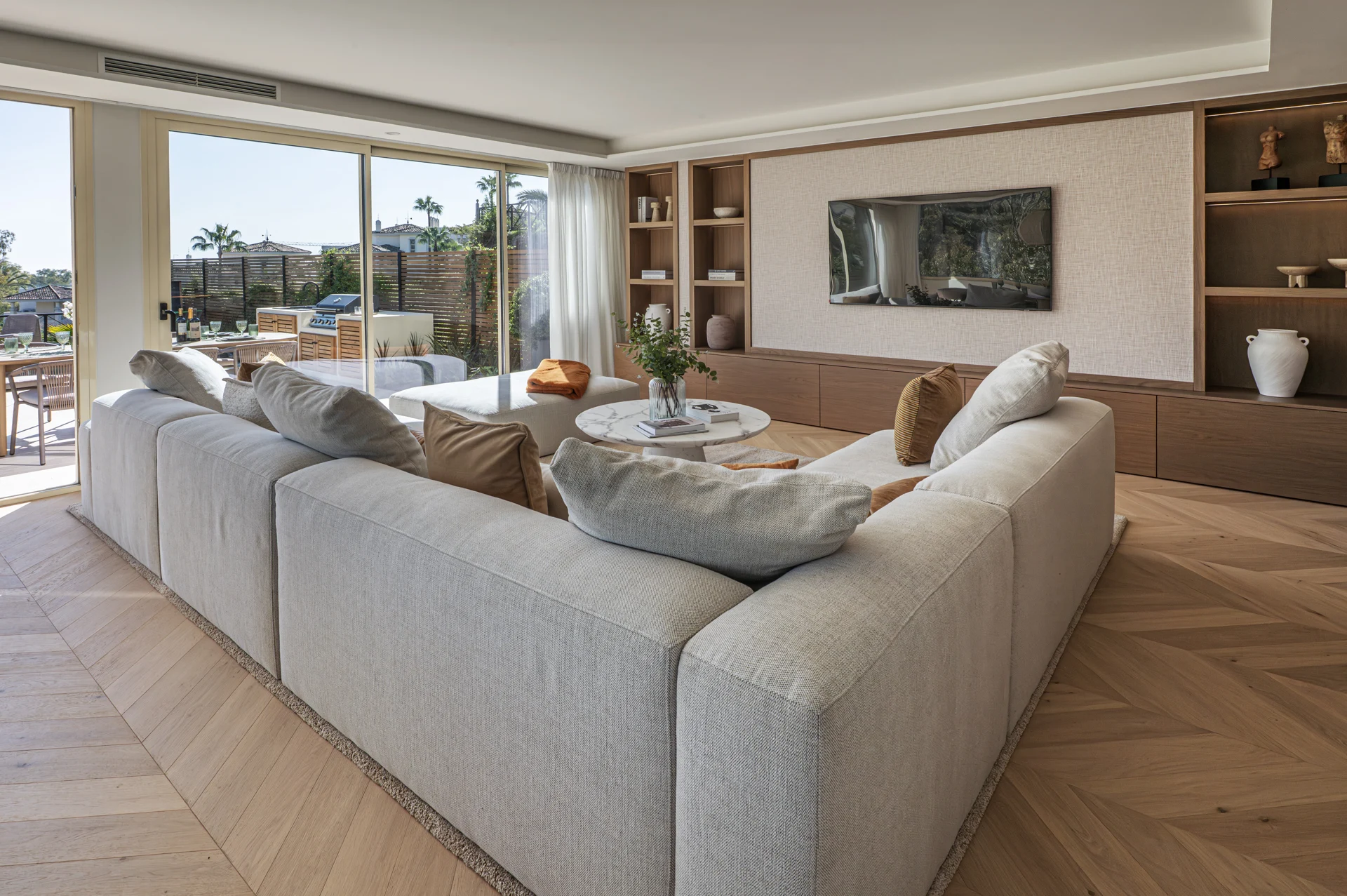 Living room opening onto the Marbella apartment terrace