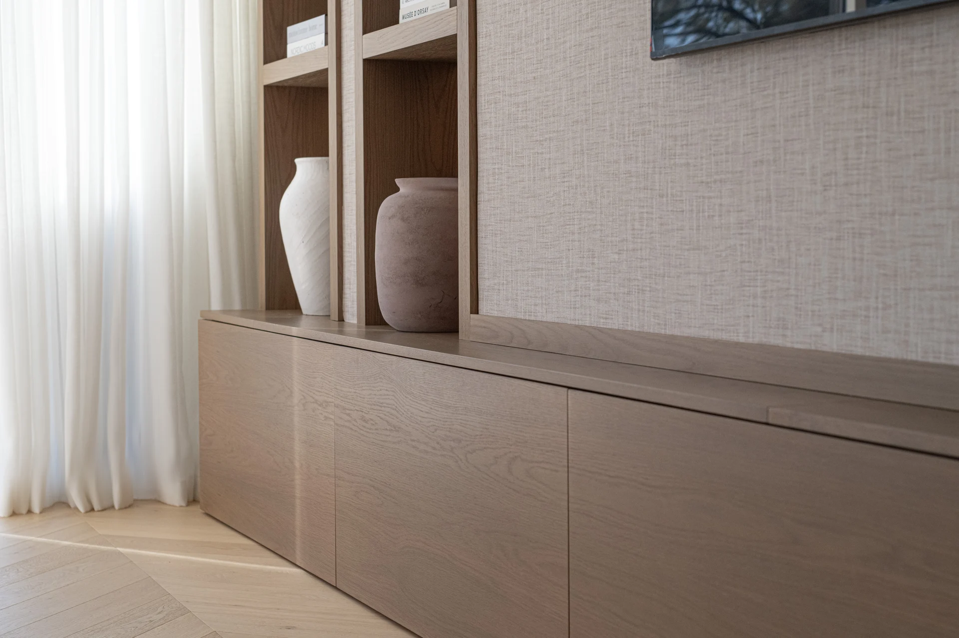 Timber shelving and textured wall finish