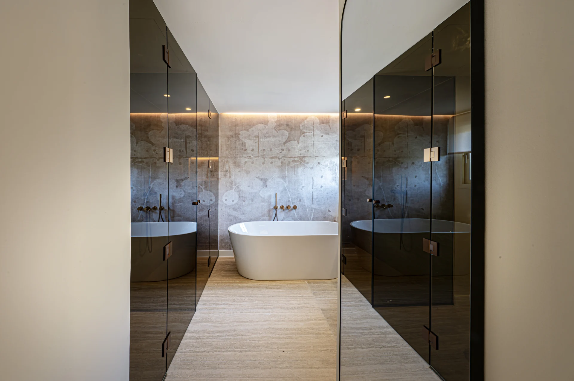 Bathroom with freestanding bath and dark glass enclosure