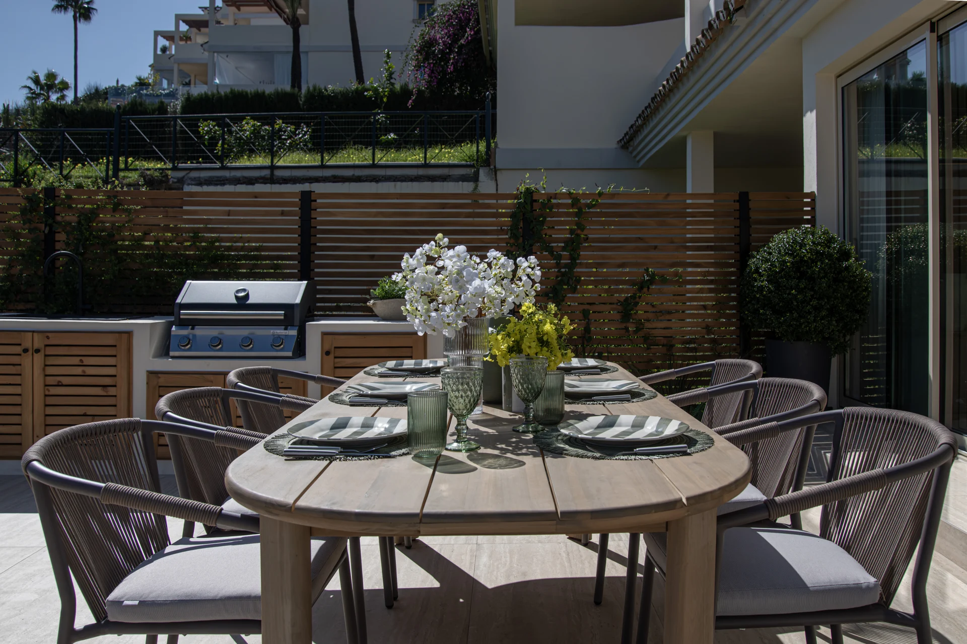 Outdoor dining table beside the barbecue kitchen