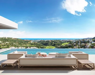 Outdoor lounge overlooking an infinity pool and the Mediterranean coastline